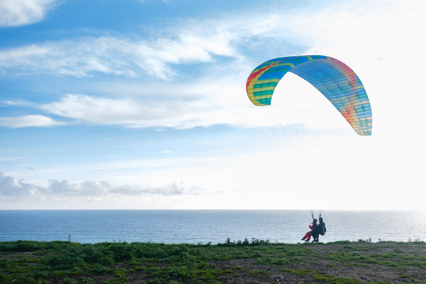 paragliding instructor prepares to fly up into the sky